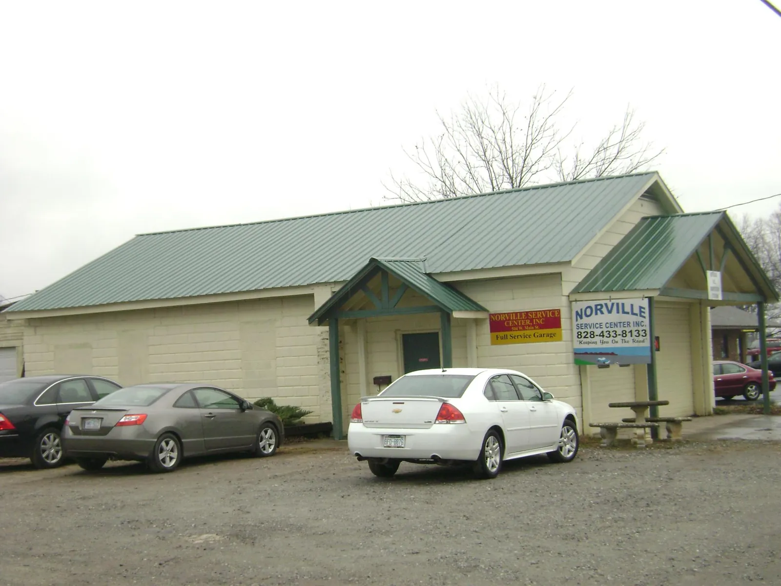 Green metal roof on a service garage with a covered entry in Damascus